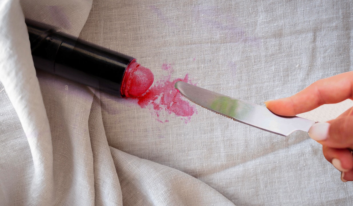 Scrape off excess lipstick before removing stain