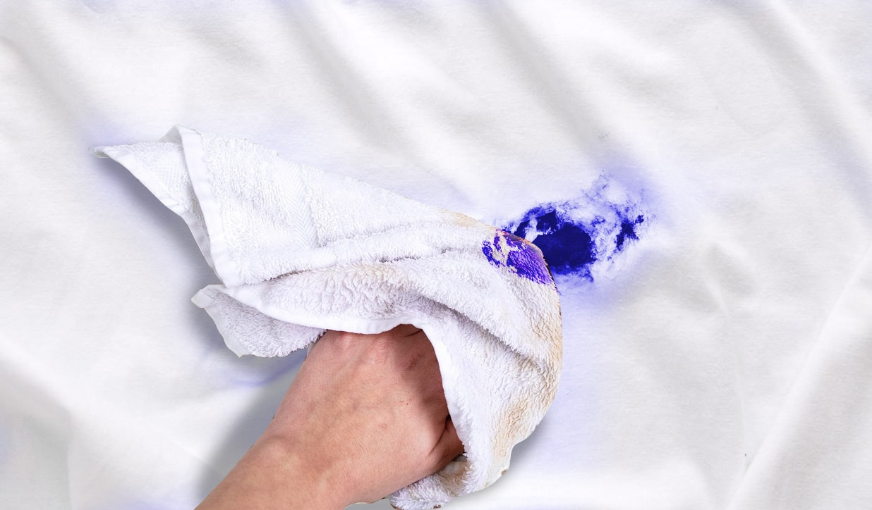Blot fresh ink stain to remove it using a white cloth